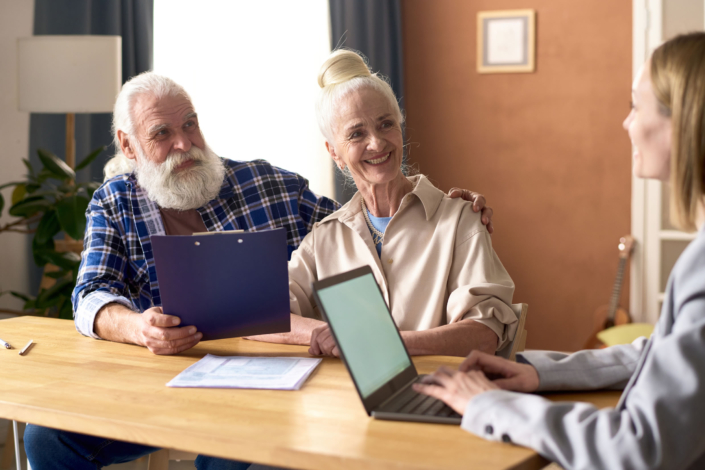 Businesswoman_Consulting_Smiling_Senior_Couple_On_Finance_original_2572242